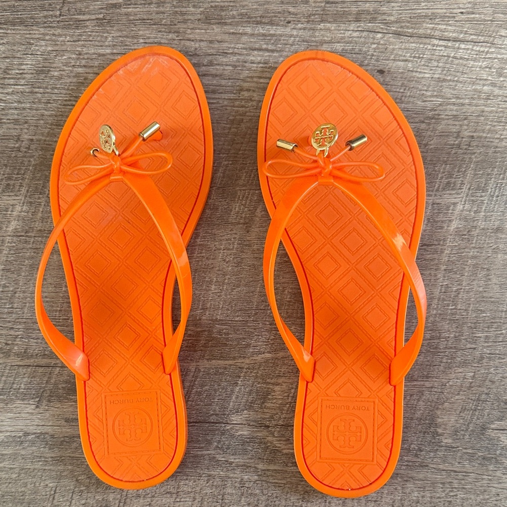 Tory Burch Bright Orange Jelly Bow Flip Sandals with Gold Logo